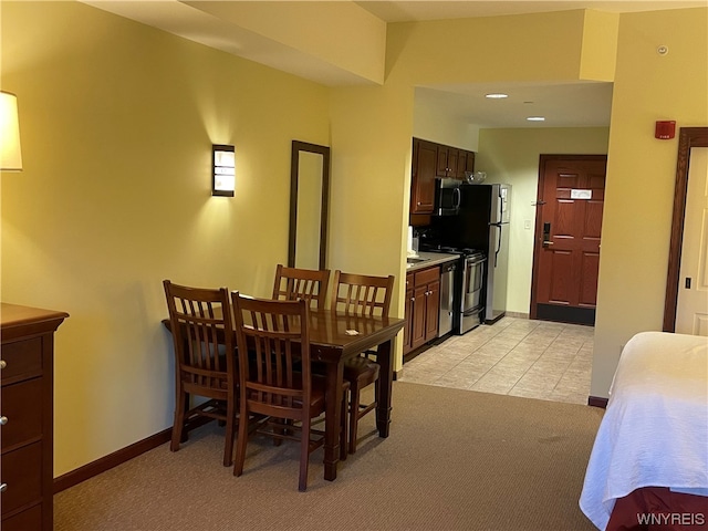 dining space featuring light tile floors