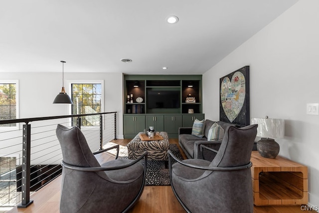 living room with light hardwood / wood-style floors and a wealth of natural light