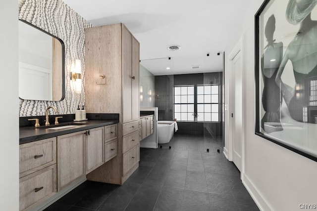 bathroom with a bath, tile flooring, and vanity