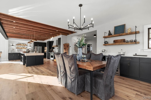 dining room with beamed ceiling, light hardwood / wood-style floors, and an inviting chandelier