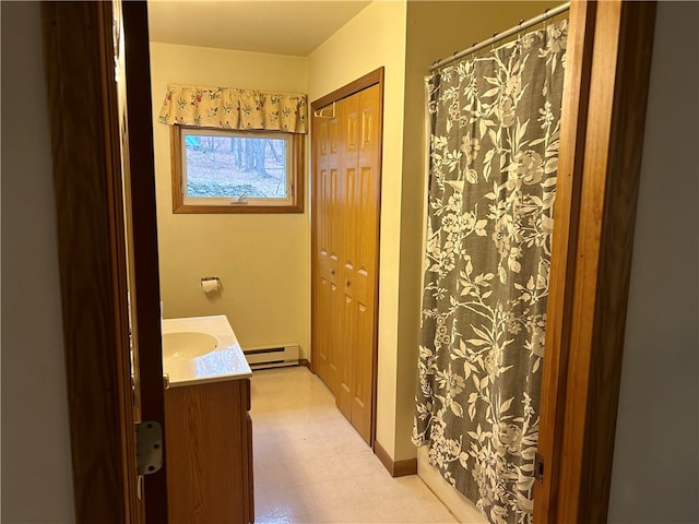 bathroom featuring a baseboard radiator, vanity, and tile floors