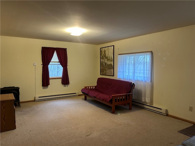 sitting room with a healthy amount of sunlight, a baseboard radiator, and carpet flooring