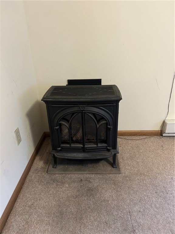 room details featuring carpet and a wood stove