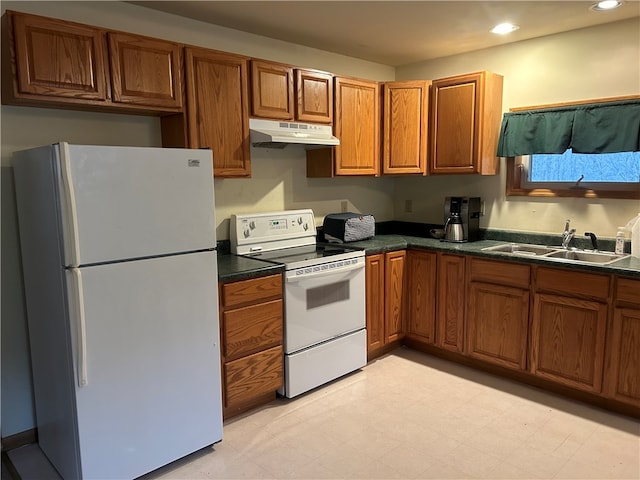 kitchen featuring white appliances, sink, and light tile floors