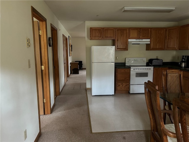 kitchen featuring tile flooring and white appliances