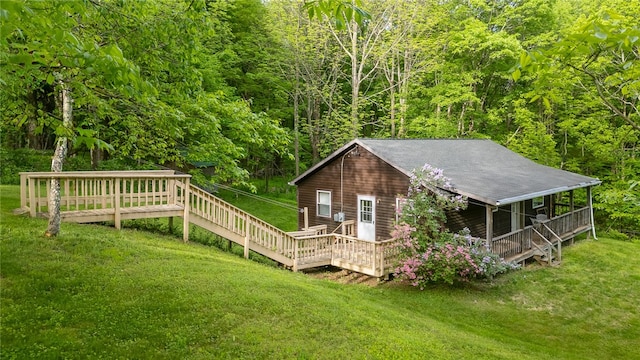 exterior space featuring a deck and a lawn