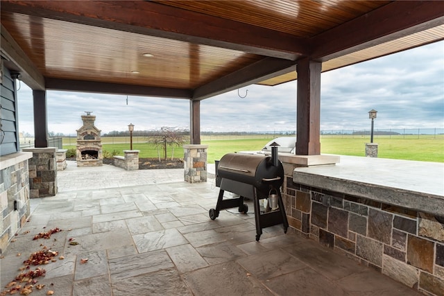 view of patio / terrace featuring an outdoor stone fireplace