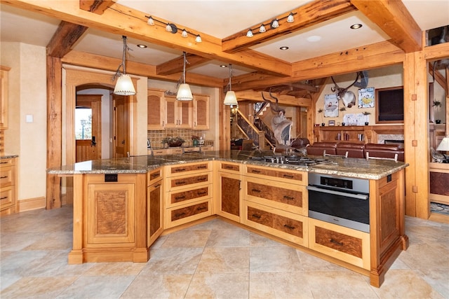 kitchen featuring beamed ceiling, pendant lighting, appliances with stainless steel finishes, tasteful backsplash, and dark stone counters