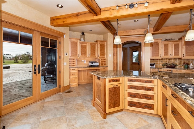 kitchen featuring dark stone counters, french doors, decorative light fixtures, and decorative backsplash