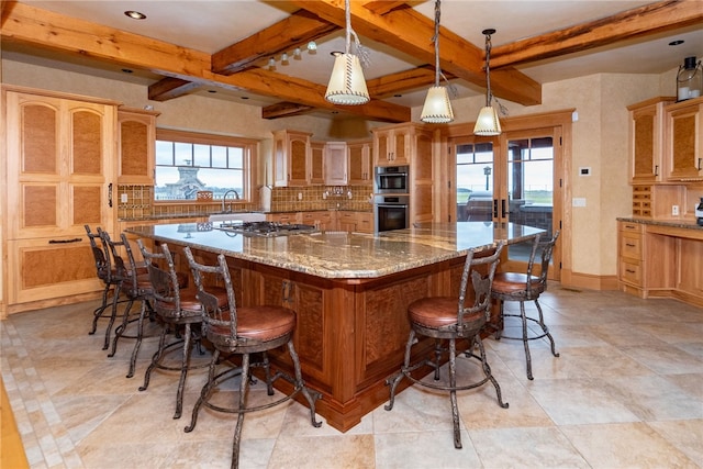 kitchen featuring plenty of natural light, stainless steel appliances, a center island, and backsplash