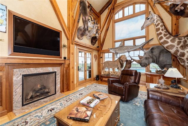 living room featuring high vaulted ceiling and a fireplace