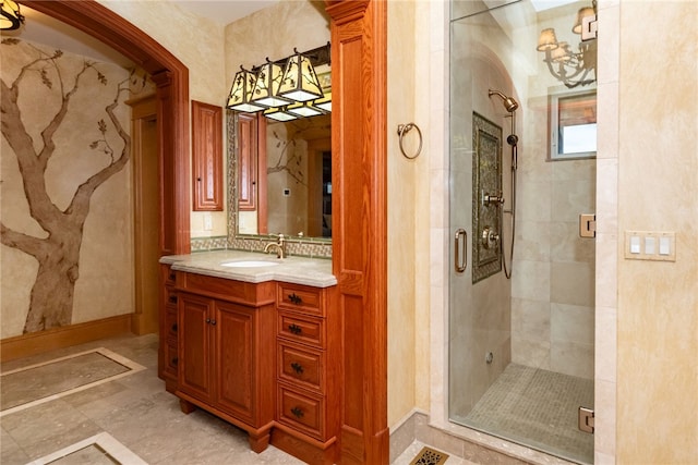 bathroom with a shower with door and vanity