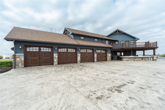 view of front of property with a garage and a deck