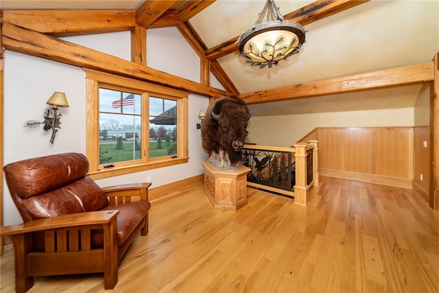 living area featuring light hardwood / wood-style floors and lofted ceiling with beams