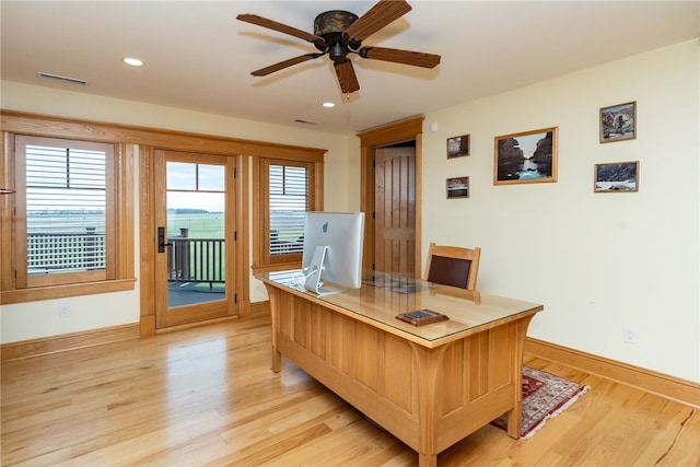 office area with plenty of natural light, ceiling fan, and light hardwood / wood-style floors