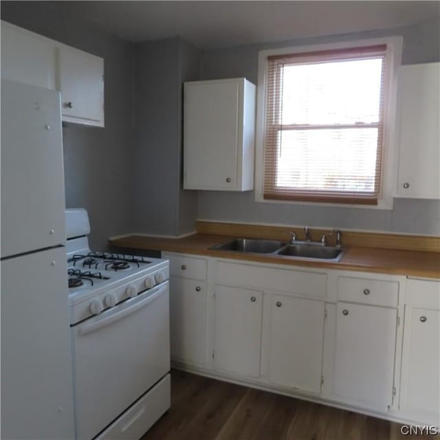 301 E Manlius St, Dewitt, NY 13057 - kitchen featuring white appliances, white cabinets, dark wood finished floors, and light countertops