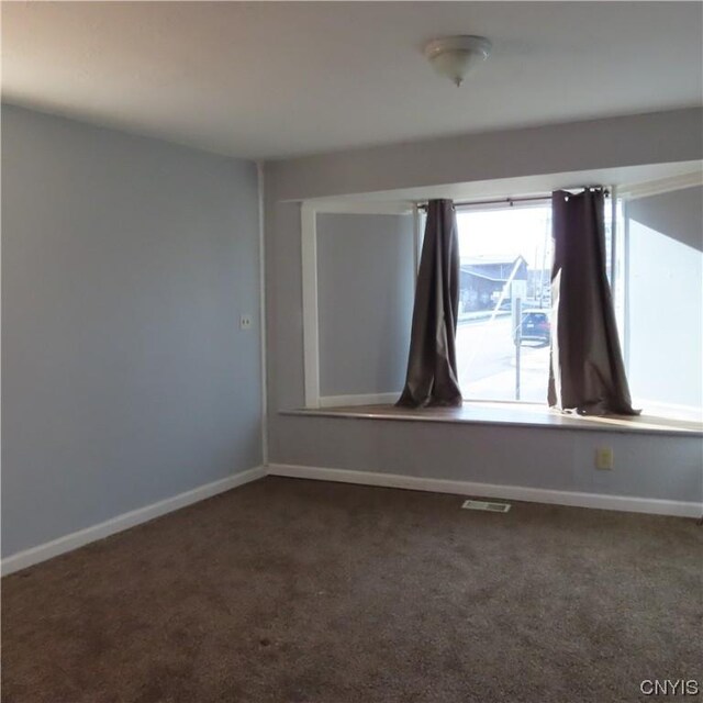 301 E Manlius St, Dewitt, NY 13057 - unfurnished room with dark colored carpet