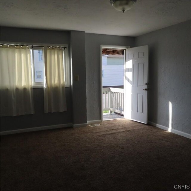 301 E Manlius St, Dewitt, NY 13057 - carpeted spare room with a textured wall and baseboards
