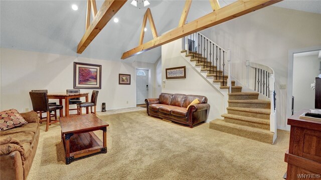 carpeted living room featuring beam ceiling and high vaulted ceiling