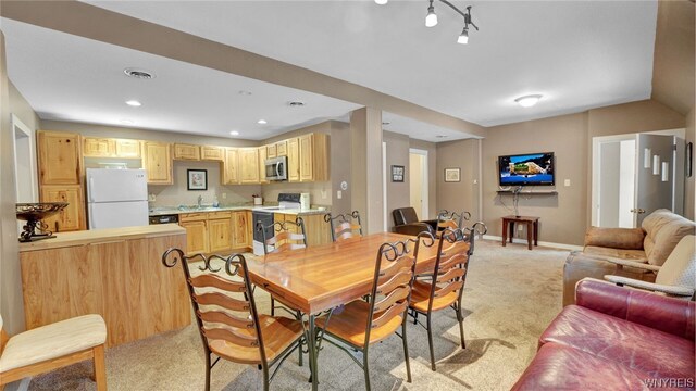 carpeted dining room featuring sink