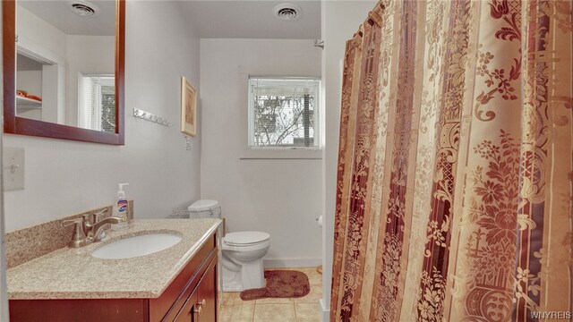 bathroom featuring tile patterned floors, vanity, and toilet