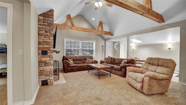 carpeted living room with beam ceiling, ceiling fan, and high vaulted ceiling