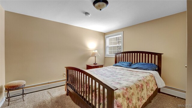 carpeted bedroom with a baseboard radiator