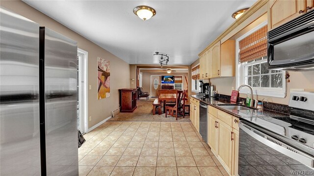 kitchen with light tile patterned flooring, light brown cabinetry, sink, and appliances with stainless steel finishes