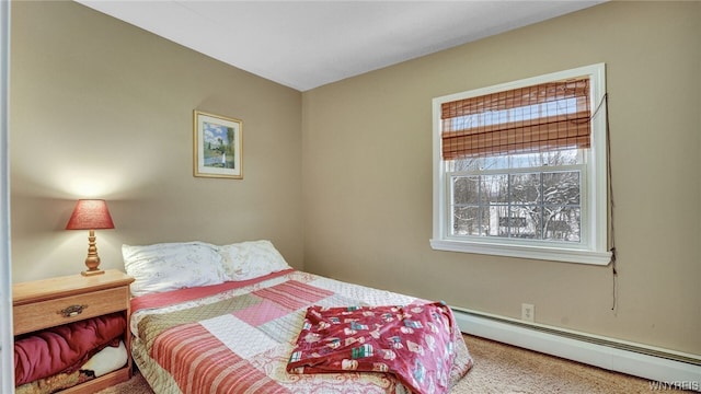 carpeted bedroom with a baseboard heating unit