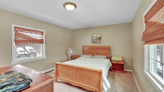 bedroom with light colored carpet, baseboard heating, and multiple windows