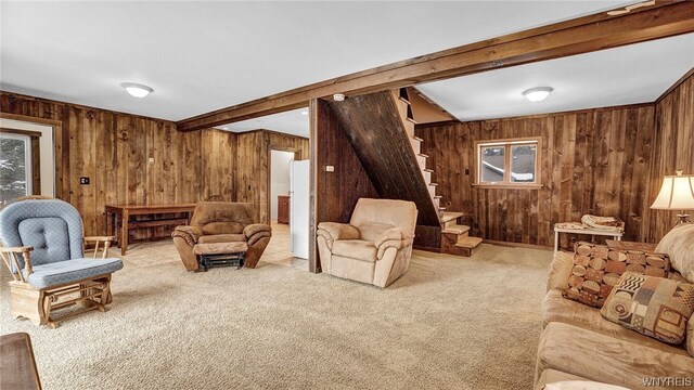 living room featuring beam ceiling, wooden walls, and carpet floors