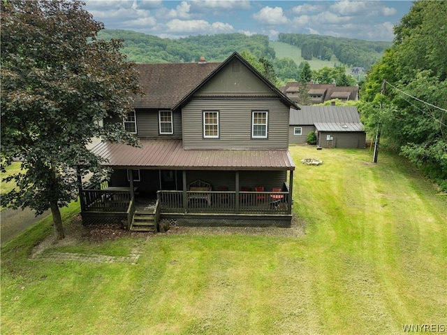 rear view of house featuring a porch