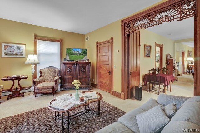 living room with light carpet and a baseboard radiator