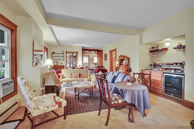 living room featuring light carpet, a baseboard heating unit, beam ceiling, wine cooler, and bar