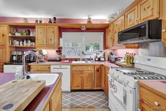 kitchen featuring white appliances and sink