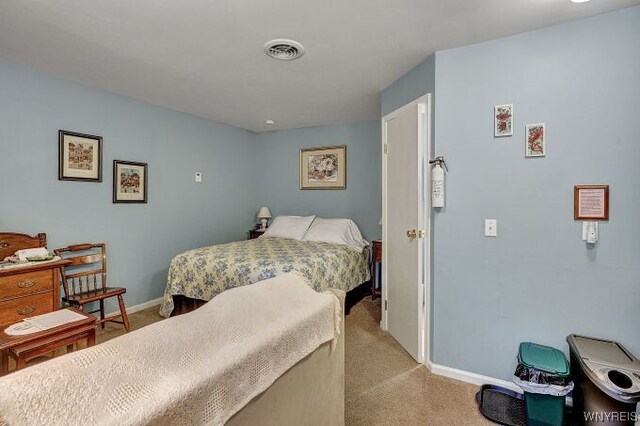 bedroom with light colored carpet