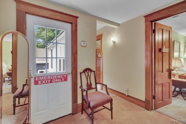 sitting room featuring light colored carpet