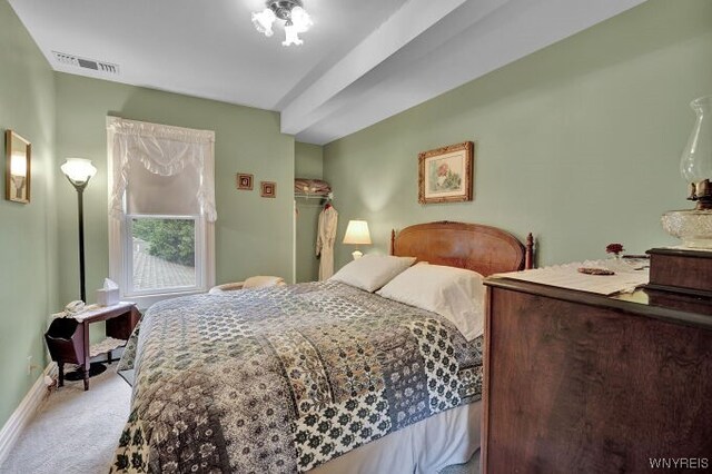 bedroom with light colored carpet