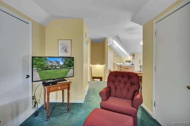 living area featuring carpet floors and lofted ceiling