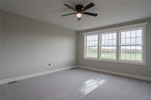 empty room featuring ceiling fan and carpet flooring