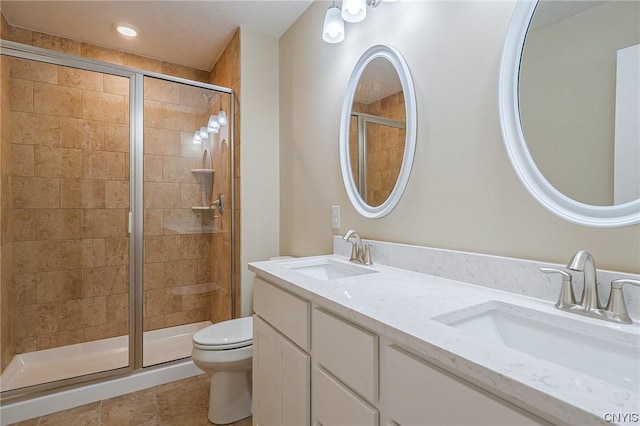 bathroom featuring toilet, tile patterned floors, walk in shower, and vanity