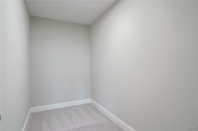 spare room featuring light colored carpet