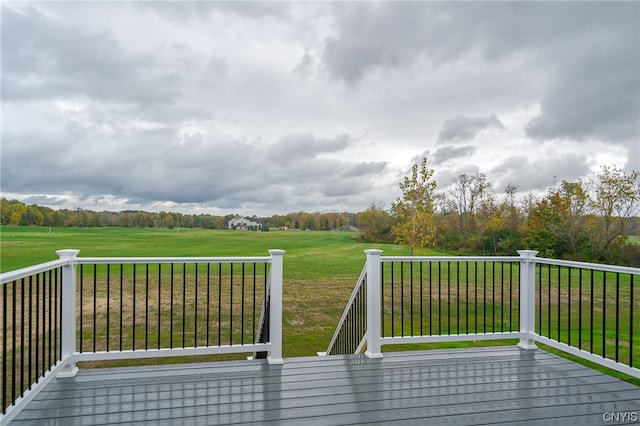 wooden deck featuring a lawn