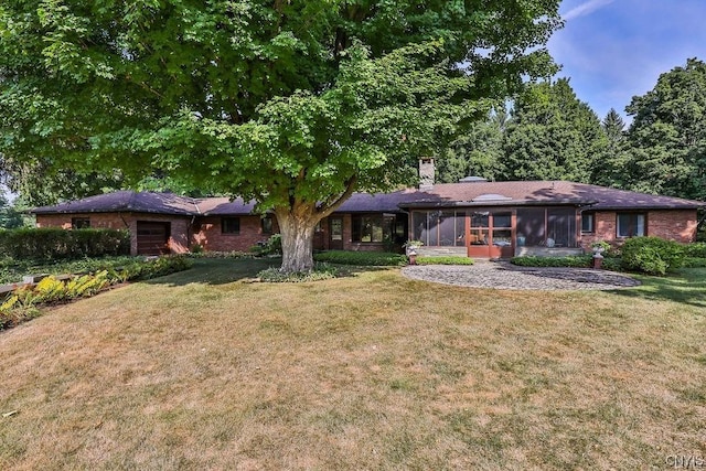 ranch-style house featuring a front yard and a sunroom