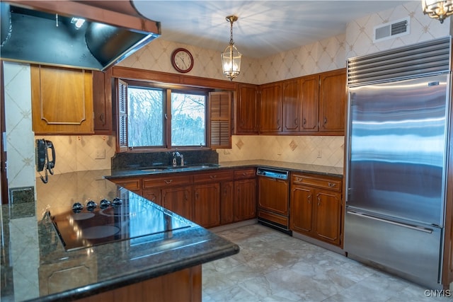 kitchen featuring stainless steel built in refrigerator, sink, paneled dishwasher, hanging light fixtures, and ventilation hood