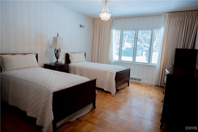 bedroom featuring a chandelier and light parquet flooring