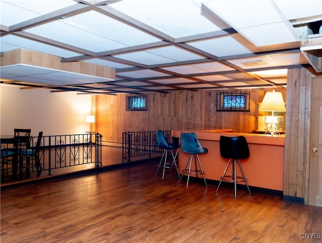 bar with wood walls and dark hardwood / wood-style floors