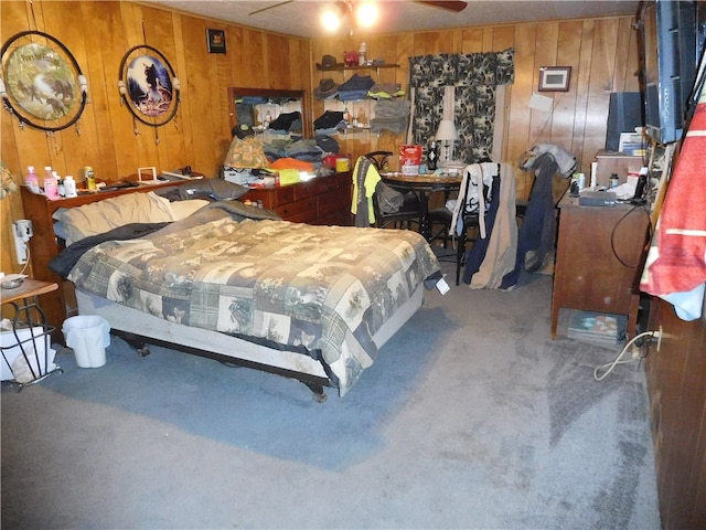 carpeted bedroom with wooden walls and ceiling fan