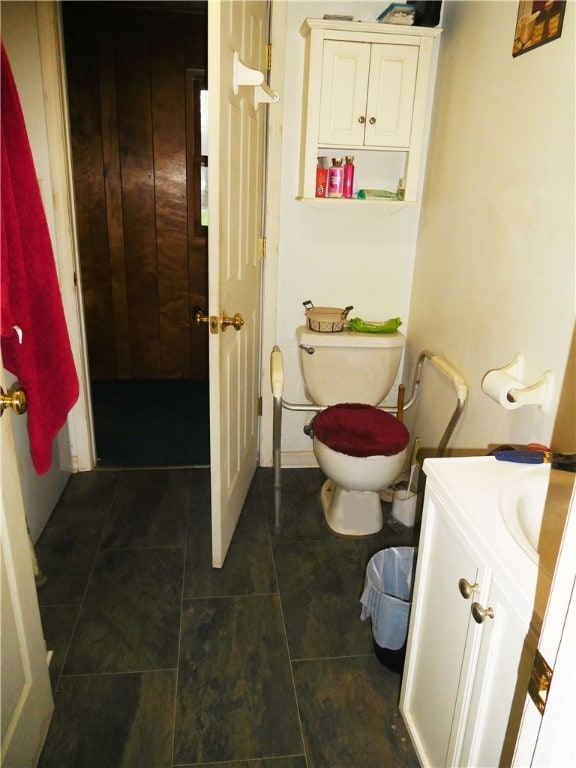 bathroom with vanity, tile patterned flooring, and toilet