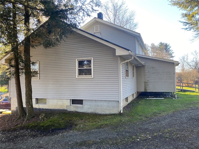 view of home's exterior with a yard